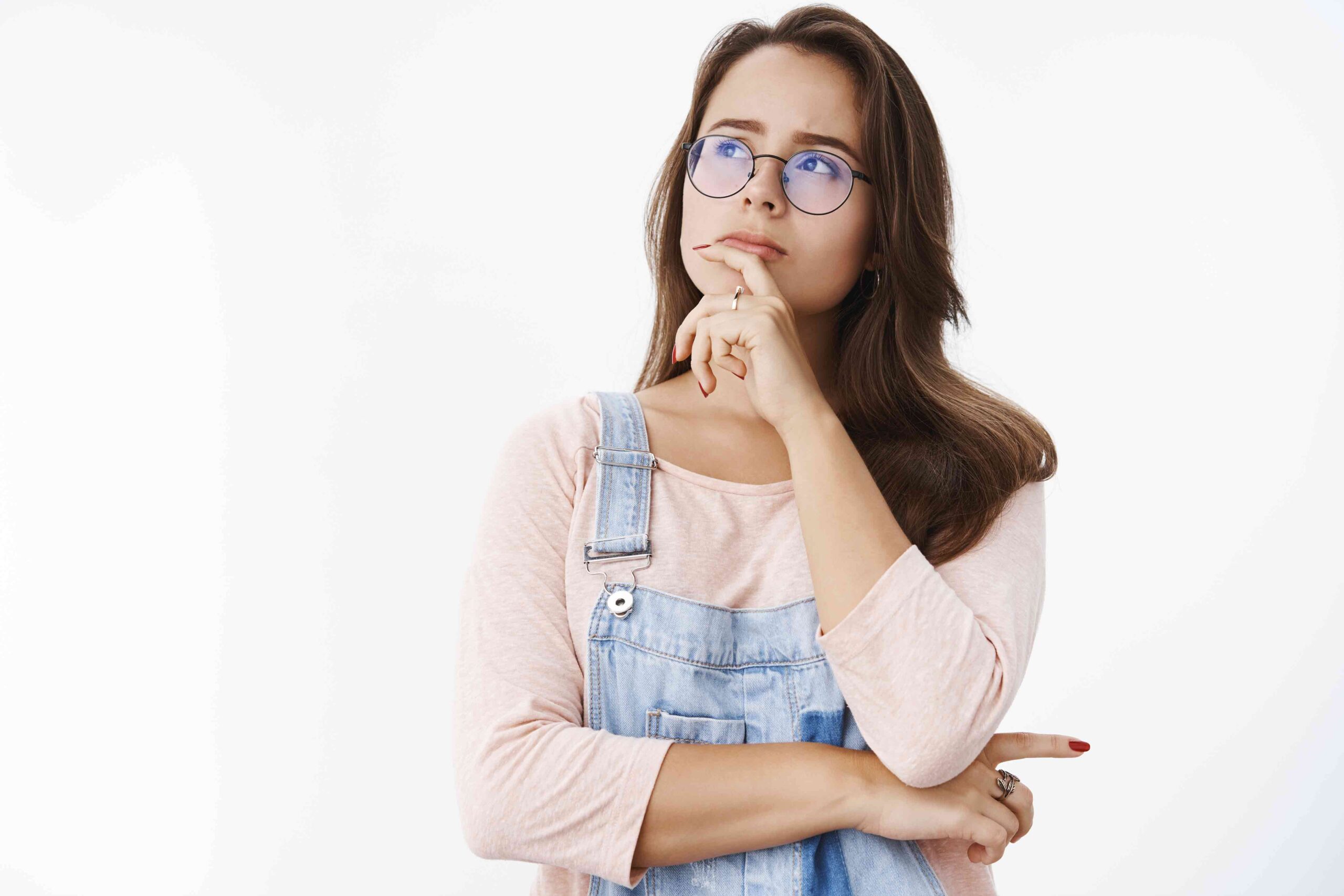 girl-makin-assumption-solving-mistery-mind-holding-finger-lip-looking-upper-left-corner-determined-thoughtful-as-thinking-making-decision-choice-standing-focused-gray-background